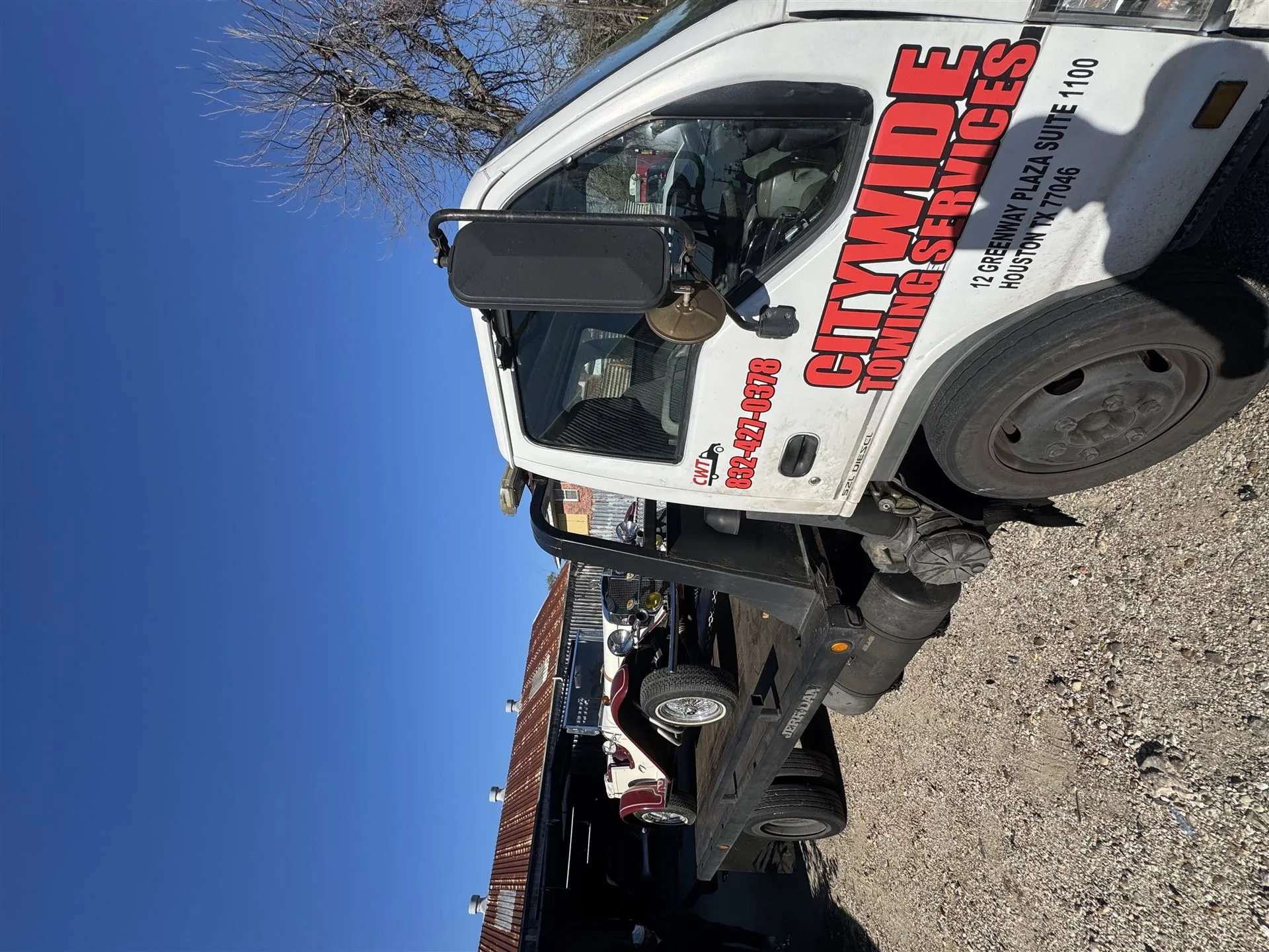 Citywide Towing Services flatbed truck door signage with phone number and address
