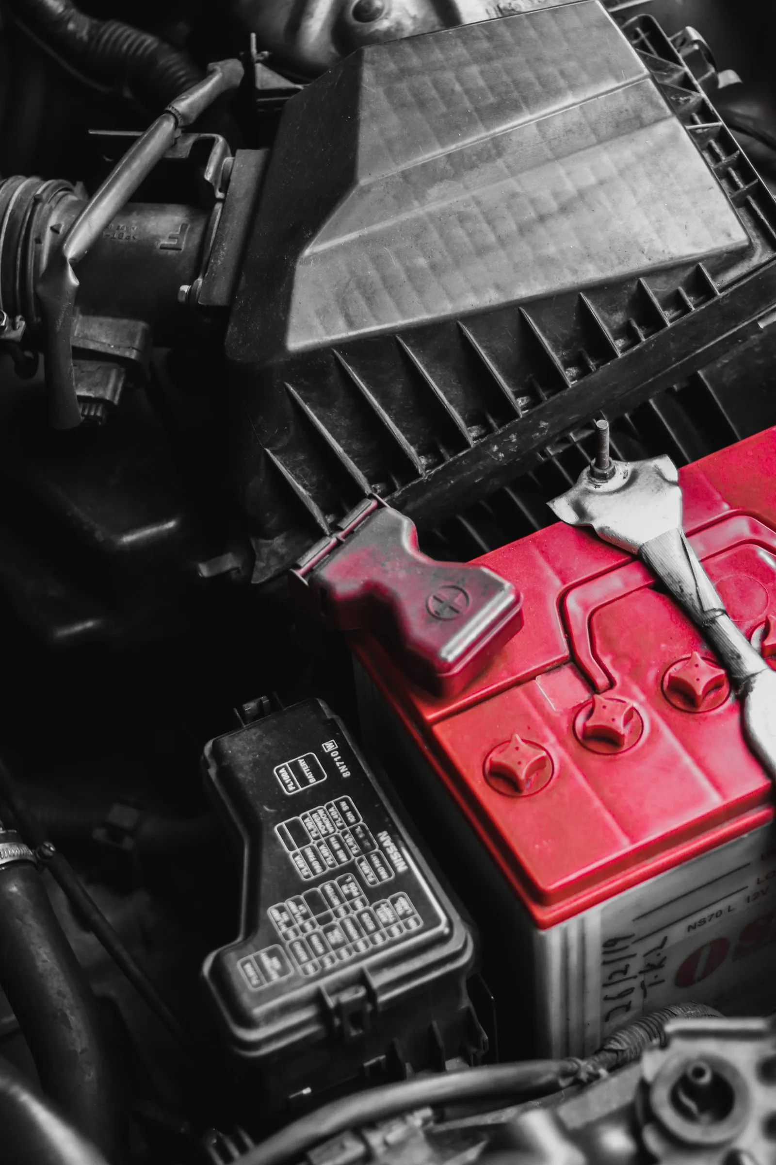 Car battery being serviced for a roadside jump start