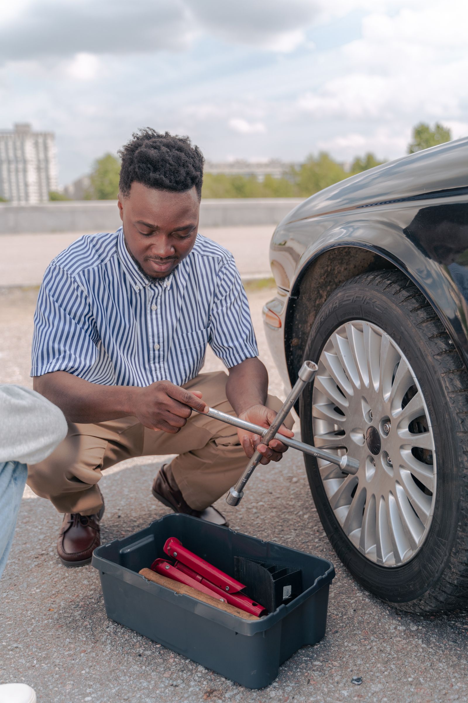 Technician changing a flat tire on the roadside